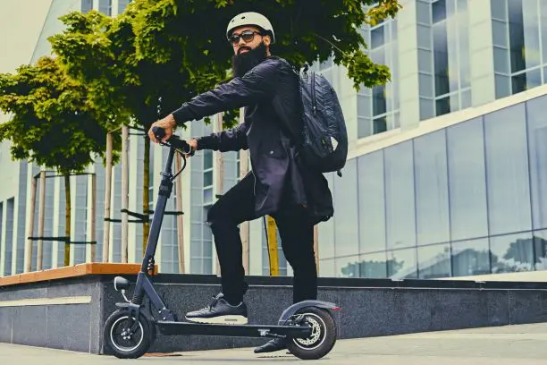 homme en trottinette électrique dans une rue parisienne moderne